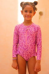 Girls long sleeve surf suit with zip front. Eco-friendly one piece with UPF 50+ sun protection. Designed in Australia for stylish, sun safe swim days.