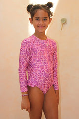 Girls long sleeve surf suit with zip front. Eco-friendly one piece with UPF 50+ sun protection. Designed in Australia for stylish, sun safe swim days.